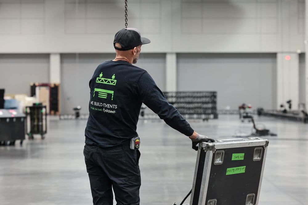 OnPoint crew member in a We Build Events shirt on a venue floor