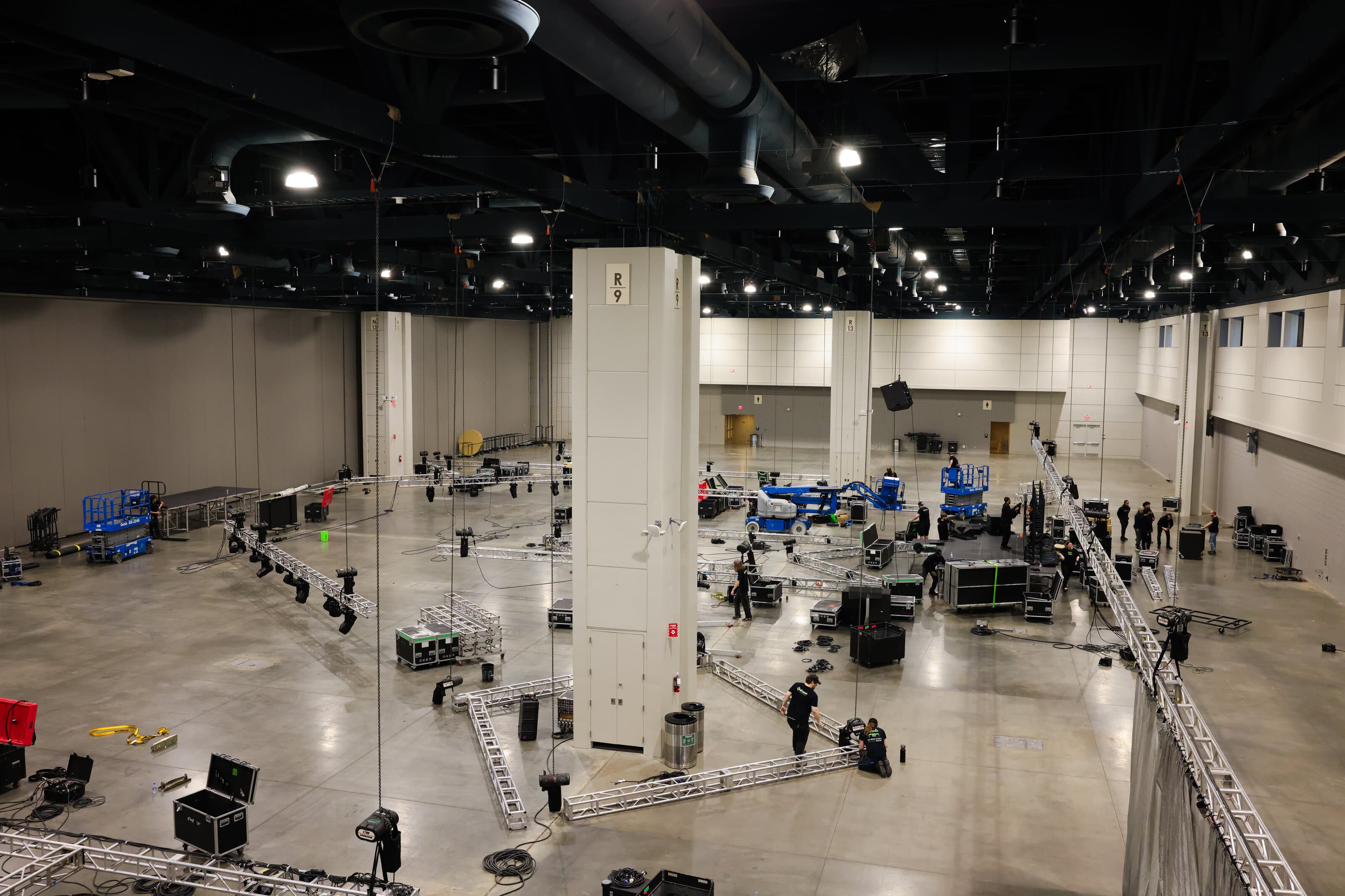 Exhibit hall transformed with rigging, lighting and drape