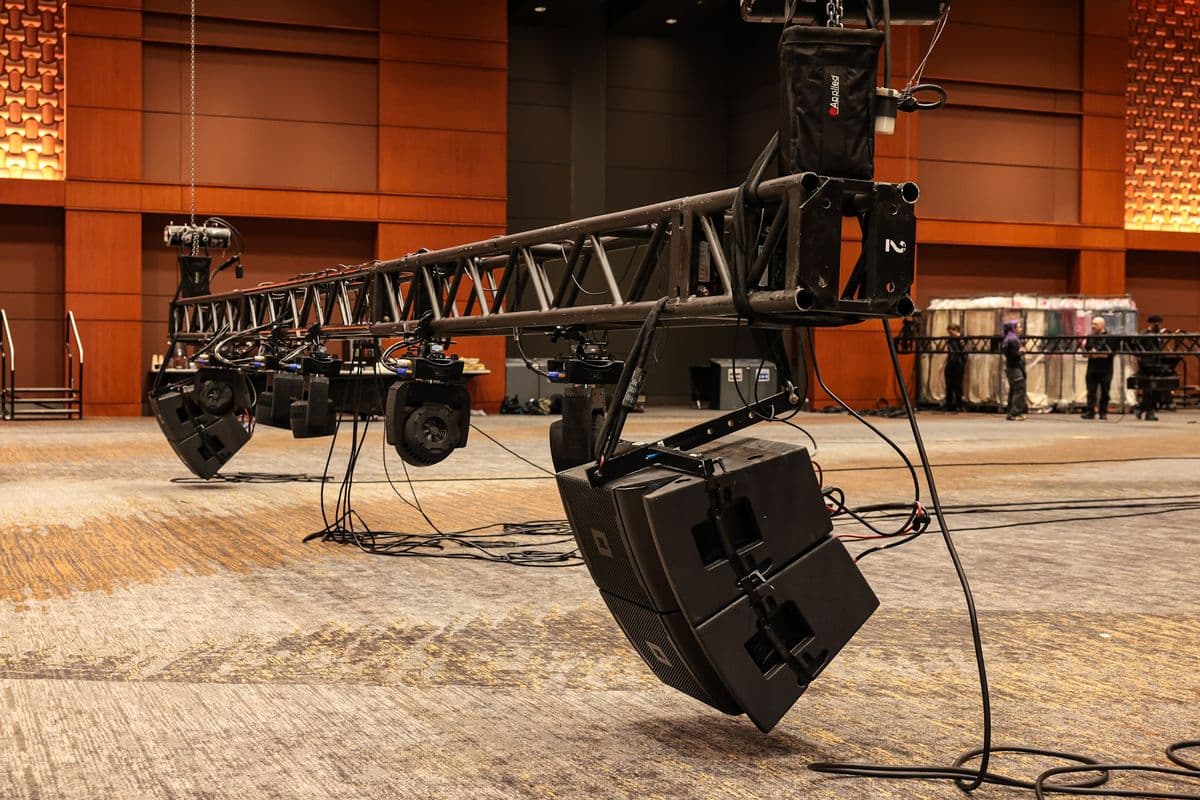 Line array and truss flown above a ballroom floor