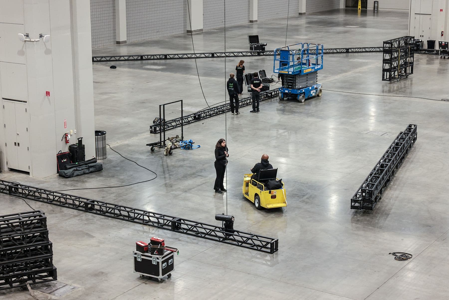 Overhead view of truss runs laid out across a convention hall during load in